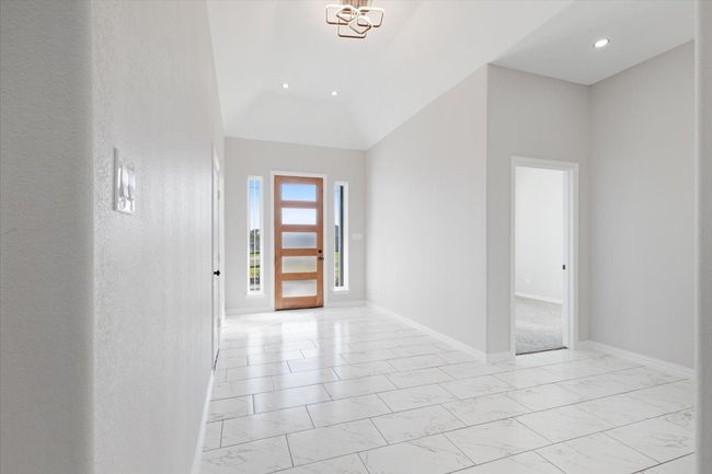 Foyer featuring light marble finish floors, recessed lighting, a chandelier, and vaulted ceiling | Image 5