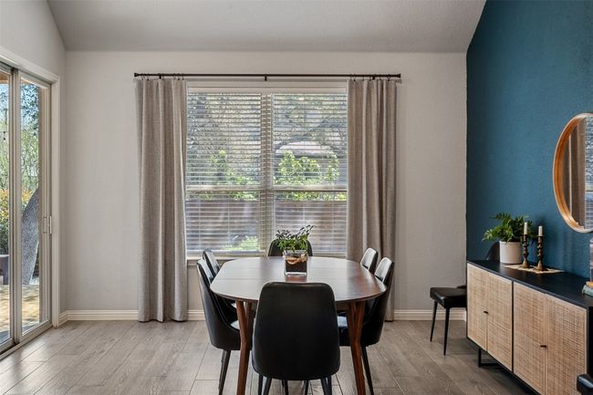 Dining area with light wood-style flooring and lofted ceiling | Image 14