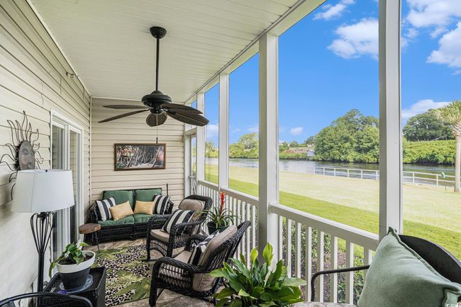 Sunroom / solarium with a water view, a ceiling fan, and outdoor lounge area | Image 18