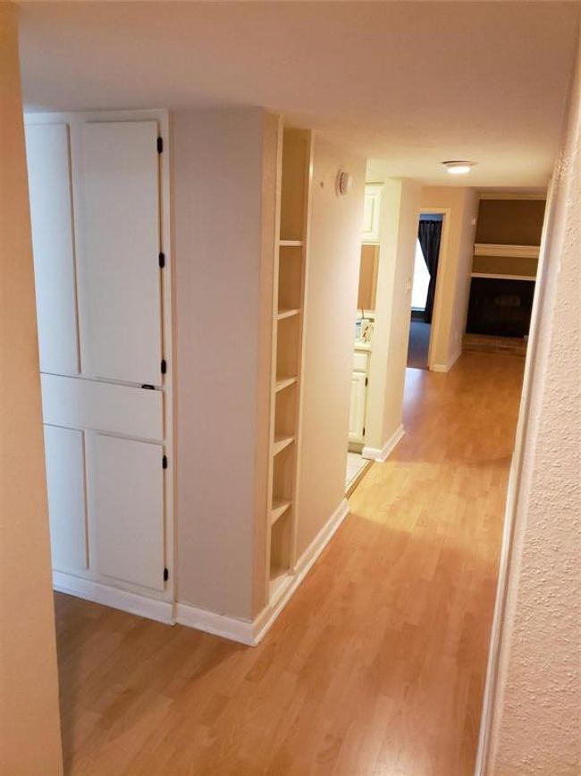Welcome Home! Entry has built-in shelves, cabinets ans a coat closet. Beautiful laminate wood floors lead you into the massive family/dining room. | Image 9