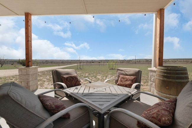 View of patio / terrace with a rural view, outdoor dining area, and fence | Image 6