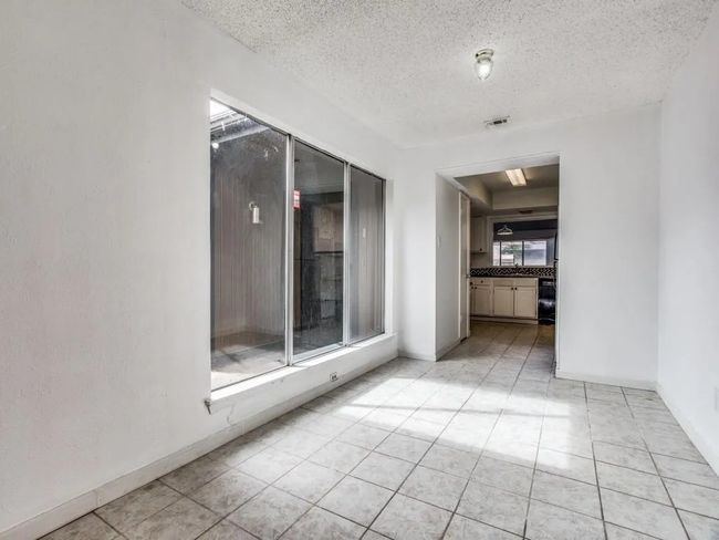 Unfurnished room featuring light tile patterned flooring and a textured ceiling | Image 8
