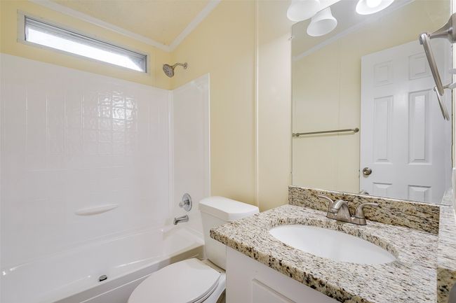 Full bathroom featuring crown molding, vanity, toilet, and tub / shower combination | Image 13