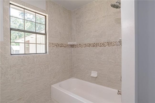 Bathroom with tiled shower / bath combo | Image 35
