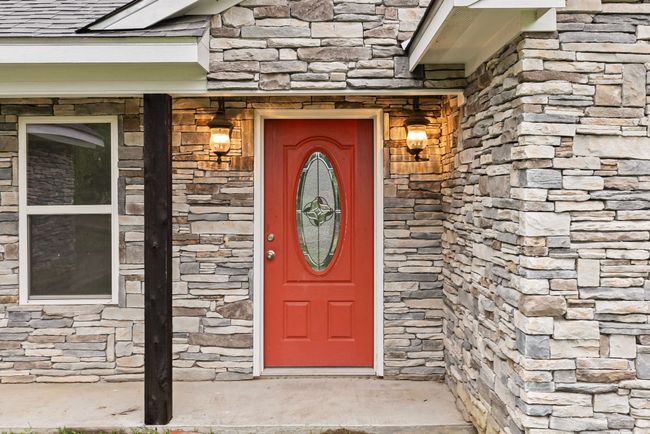 View of exterior entry featuring stone siding | Image 4