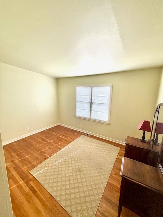 Living area with baseboards, visible vents, and wood finished floors | Image 13