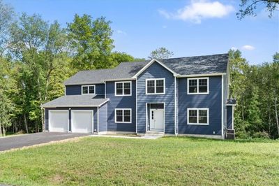 View of front of home with a garage and a front yard | Image 1