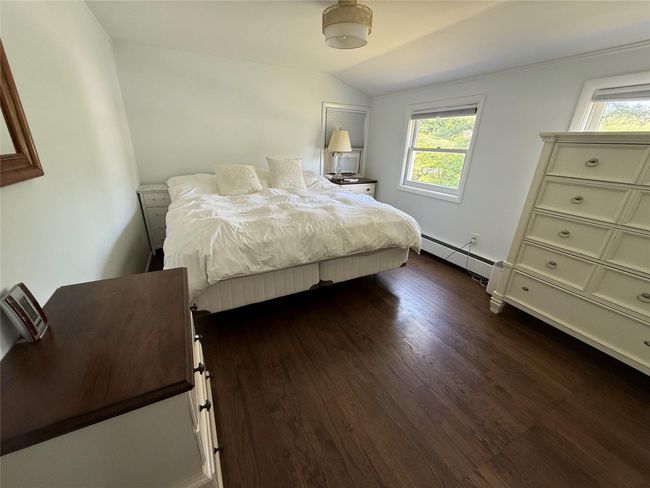 Large bedroom with light colored walls and beautiful hardwood floors, good natural light create a relaxing environment. | Image 20