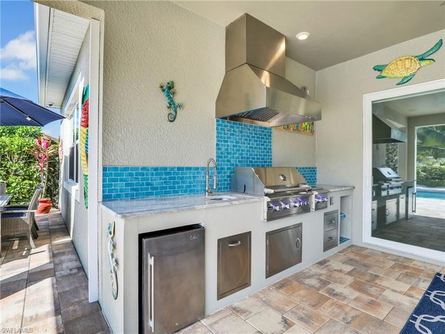 View of patio / terrace featuring area for grilling, exterior kitchen, and sink | Image 39
