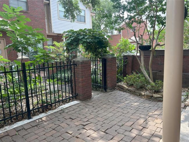 Here is another view of the courtyard from the front porch, a little bit of an urban garden where you can enjoy the pleasure of a green thumb without a major maintenance commitment. | Image 9