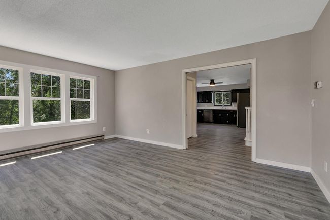 Living room adjacent to kitchen create great flow throughout the main level | Image 6