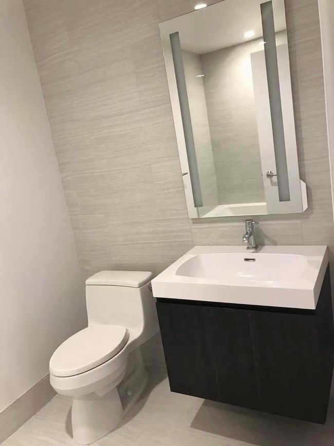 Bathroom featuring tile walls and vanity | Image 4