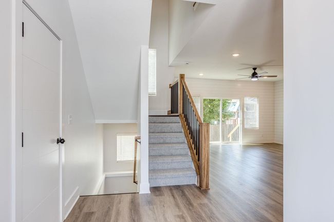 Stairway with wood finished floors, ceiling fan, recessed lighting, and baseboards | Image 4
