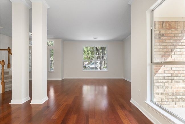 Spare room featuring wood finished floors and stairs | Image 4