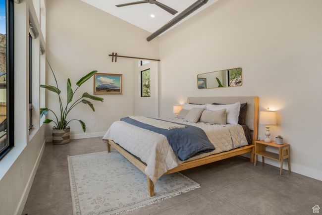 Bedroom with baseboards, a high ceiling, and finished concrete flooring | Image 20