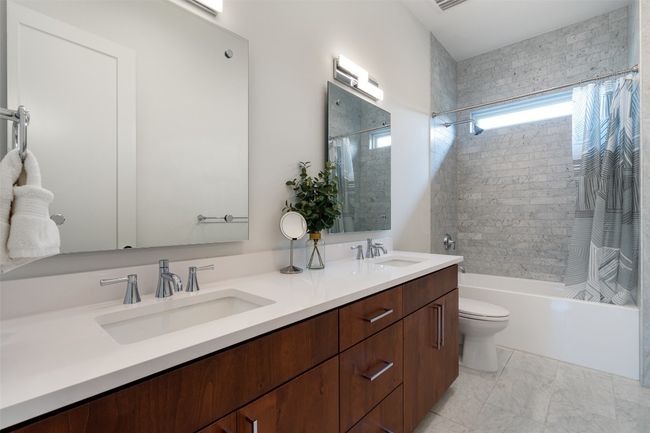 Dual sinks and designer tile add a polished touch to this guest bath. | Image 35