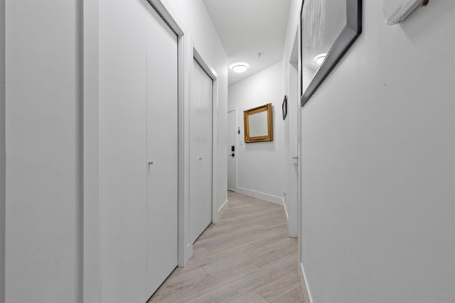 Corridor featuring baseboards and light wood-style flooring | Image 27