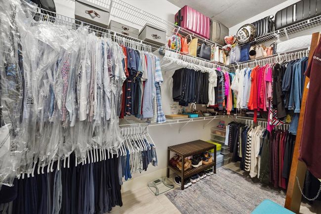 The expansive primary closet offers abundant shelving and storage space to help keep everything organized. | Image 12