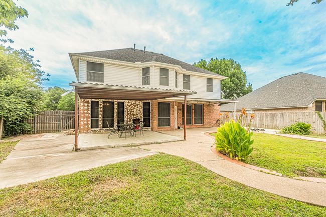 Rear view of property with a patio, a fenced backyard, and brick siding | Image 36