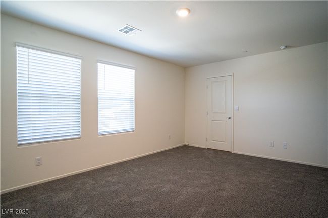 Spare room featuring dark carpet and baseboards | Image 11