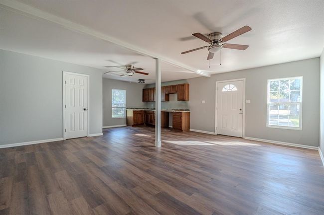 A spacious garage apartment with an open floor plan and ample natural light. Accessible plumbing and electrical connections. | Image 23