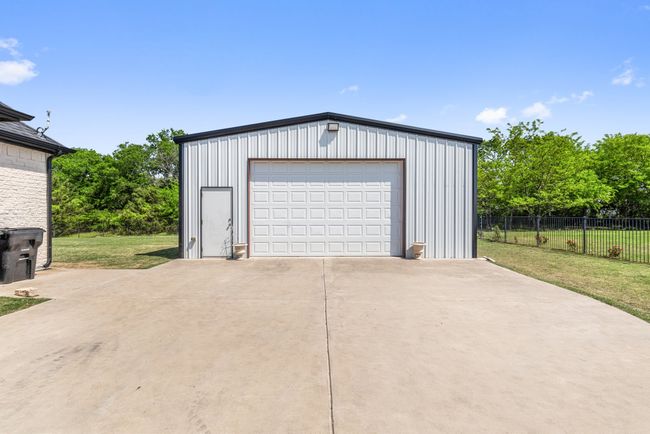 Detached garage featuring fence | Image 32