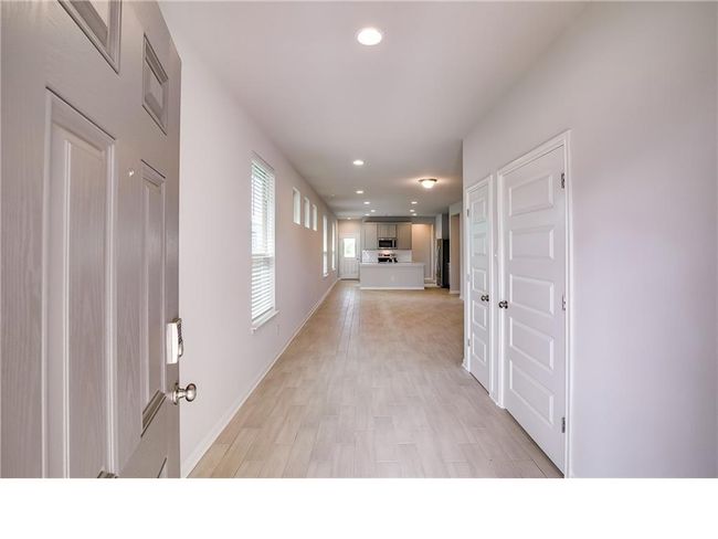 Hallway with recessed lighting and light wood-style flooring | Image 4
