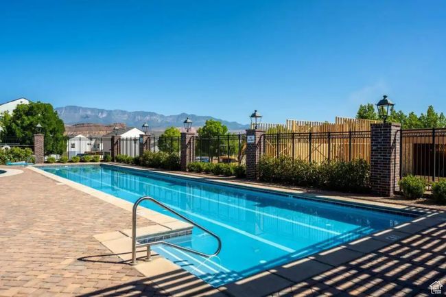 View of swimming pool featuring a mountain view and a patio area | Image 47