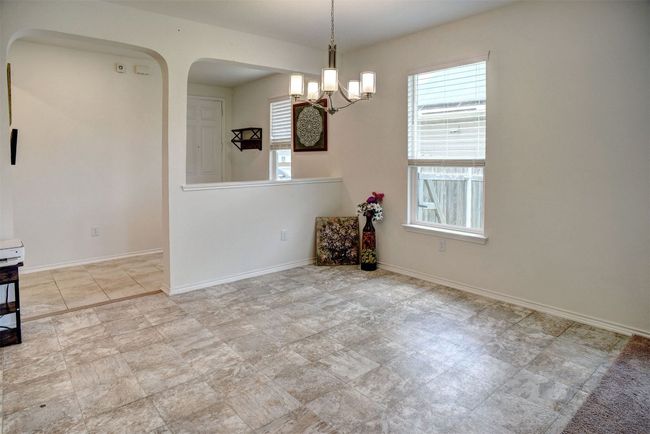 Dining area featuring arched walkways and a chandelier | Image 19