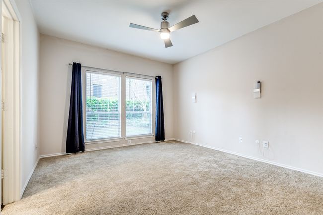 Carpeted spare room featuring a ceiling fan and baseboards | Image 9