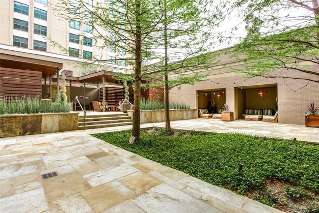 Courtyard with covered sitting areas and outdoor fireplace. There is also a separate dog park so even your dog can socialize! | Image 33