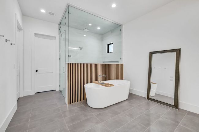 Spa like Primary Bathroom with a freestanding bathtub, a walk in shower, and tile patterned flooring | Image 23