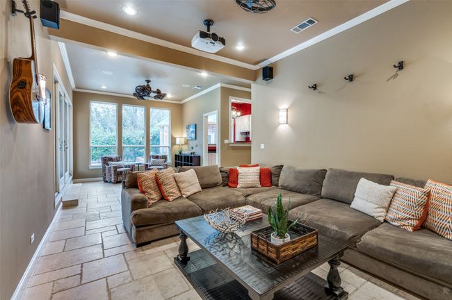 Living area featuring stone tile flooring, baseboards, recessed lighting, and crown molding | Image 12
