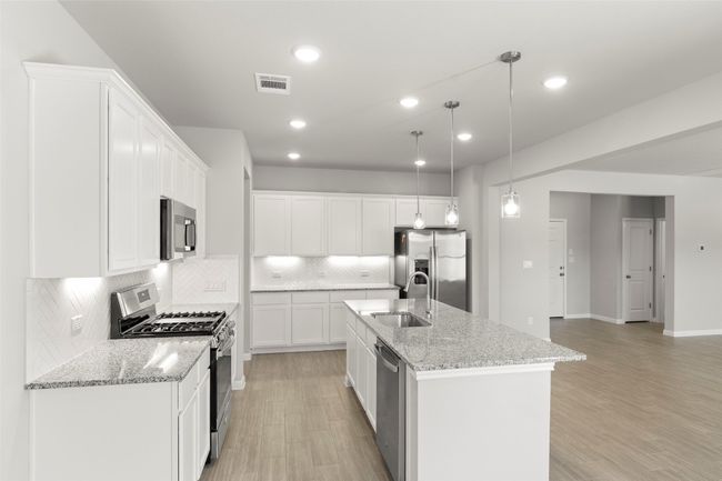 Kitchen with stainless steel appliances, a sink, tasteful backsplash, light wood finished floors, and recessed lighting | Image 13