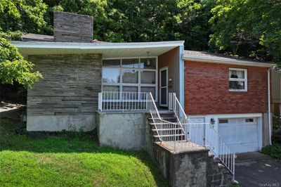 View of front facade featuring a garage and a front yard | Image 1