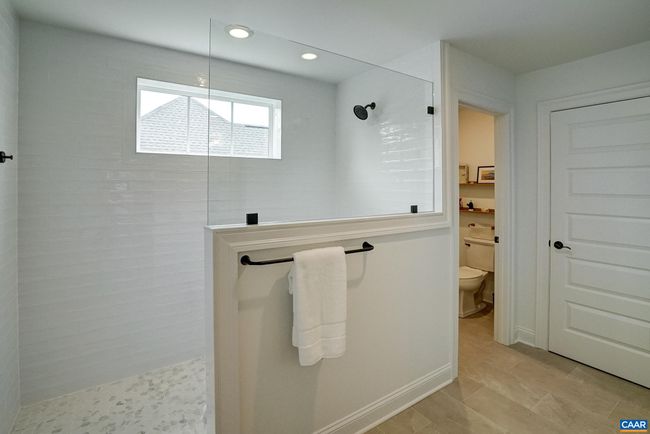 Spacious walk-in shower with frameless glass and a separate water closet. | Image 33