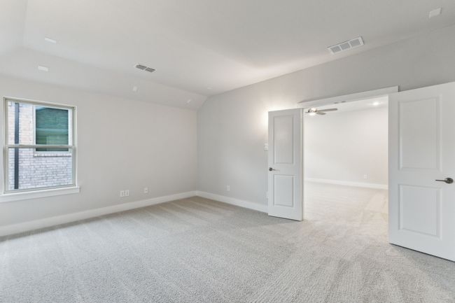 Spare room with light carpet, vaulted ceiling, and a ceiling fan | Image 32