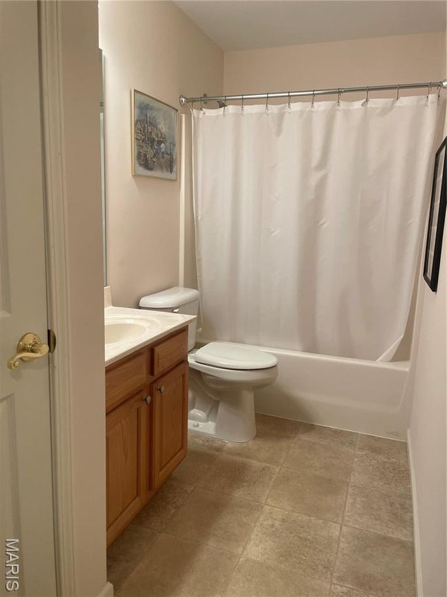 Full bathroom with vanity, toilet, and shower / bath combo with shower curtain | Image 17