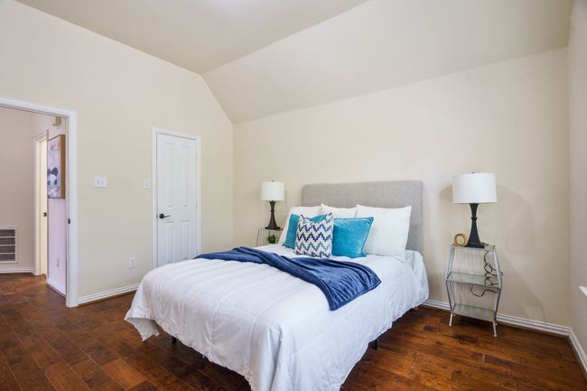Bedroom featuring baseboards, vaulted ceiling, closet and wood flooring | Image 18
