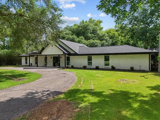 Striking modern farmhouse with fresh paint, new roof, and inviting circular drive nestled on 5 wooded acres. | Image 13