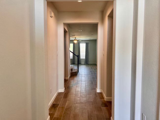 Corridor featuring dark wood finished floors, stairway, and recessed lighting | Image 8