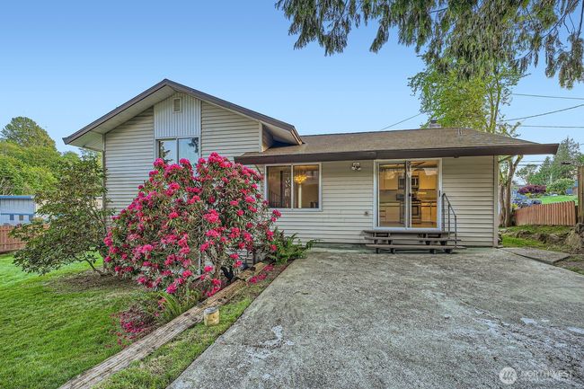 Large entertaining area with mature landscaping and privacy. Easy access to kitchen with sliding glass door. 2nd small patio outside lower level sliding glass door hiding behind the beautiful rhody. | Image 32