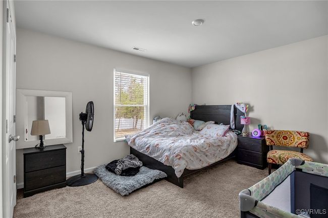 Carpeted bedroom featuring baseboards and visible vents | Image 18
