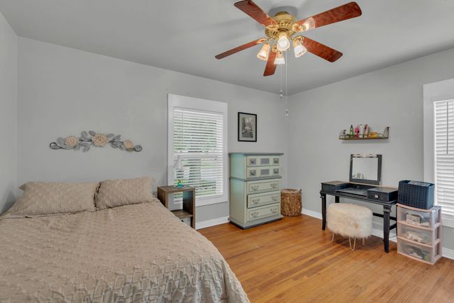Bedroom featuring light wood-style flooring, baseboards, and a ceiling fan | Image 12