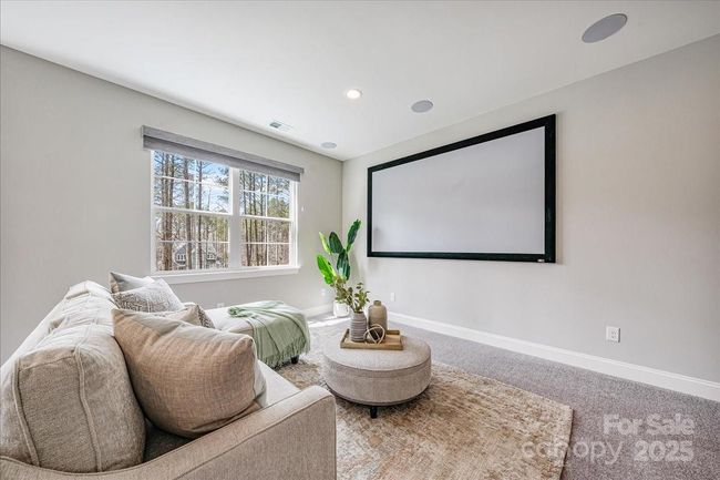 Enjoy an oversized bonus room on the second level- the seller has provided a projection screen and projector- perfect for hanging out with friend and family or watching a game | Image 22
