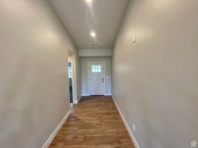 Doorway featuring wood finished floors, recessed lighting, visible vents, and baseboards | Image 7