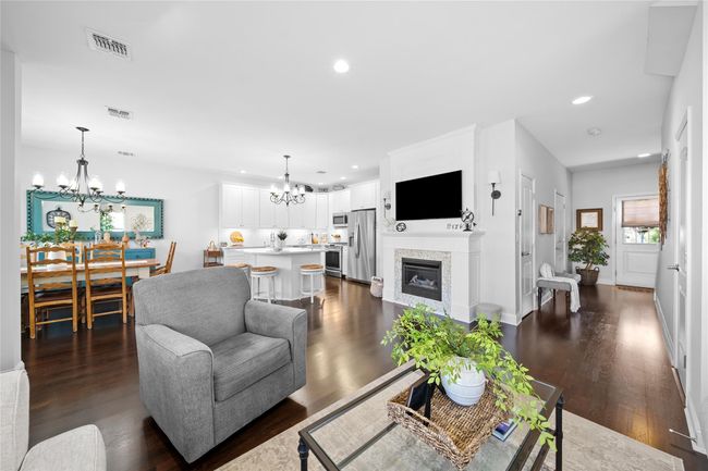 Living room featuring visible vents, dark wood-style flooring, recessed lighting, and a chandelier | Image 11