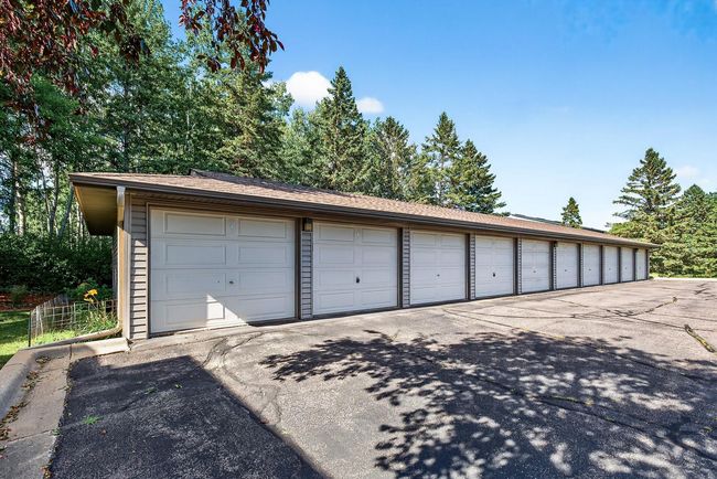 There is an oversized one car garage which is extra deep and offers storage space in the back of the garage. Unit #110 is the second garage to the right and very close to the main entrance of the building. | Image 22