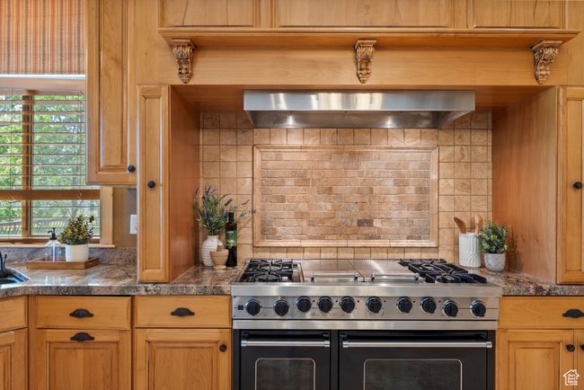 Kitchen with range with two ovens, ventilation hood, plenty of natural light, and decorative backsplash | Image 33