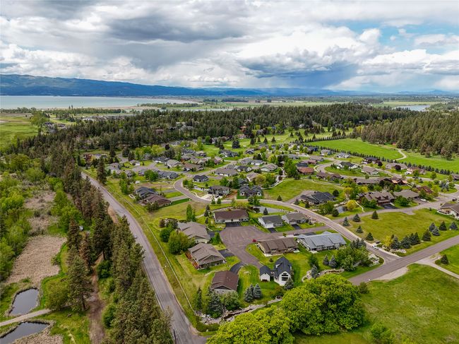 Aerial perspective of suburban area with a nearby body of water | Image 32